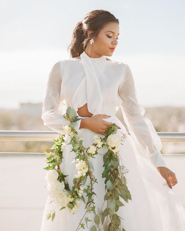 Forget the bridal bouquet, how about florals trailing up your arm?! 🌿 The coolest "arrangement" we have ever seen created by @wimberlyfair for @emilykotarskibridal collection last year. 👰🏾❤️📷 by @clayaustin